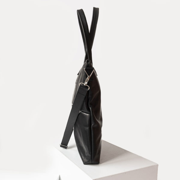 Seitenansicht der Wickeltasche MIA MIDI aus nachhaltigem Naturleder in Schwarz geölt mit abnehmbarem Umhängegurt